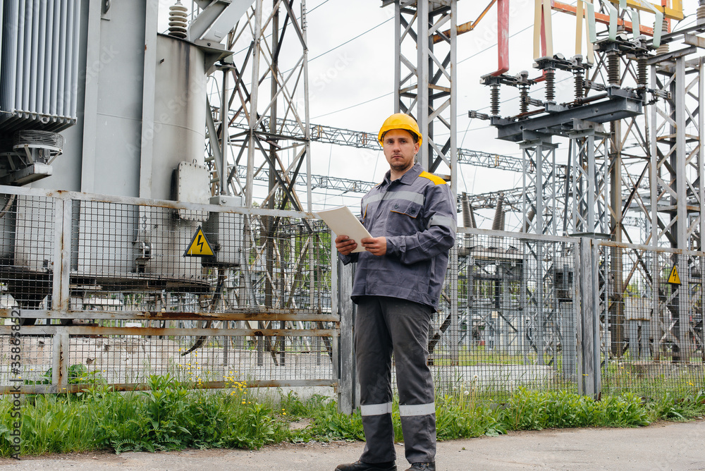 The energy engineer inspects the equipment of the substation. Power engineering. Industry The energy engineer inspects the equipment of the substation. Power engineering. Industry