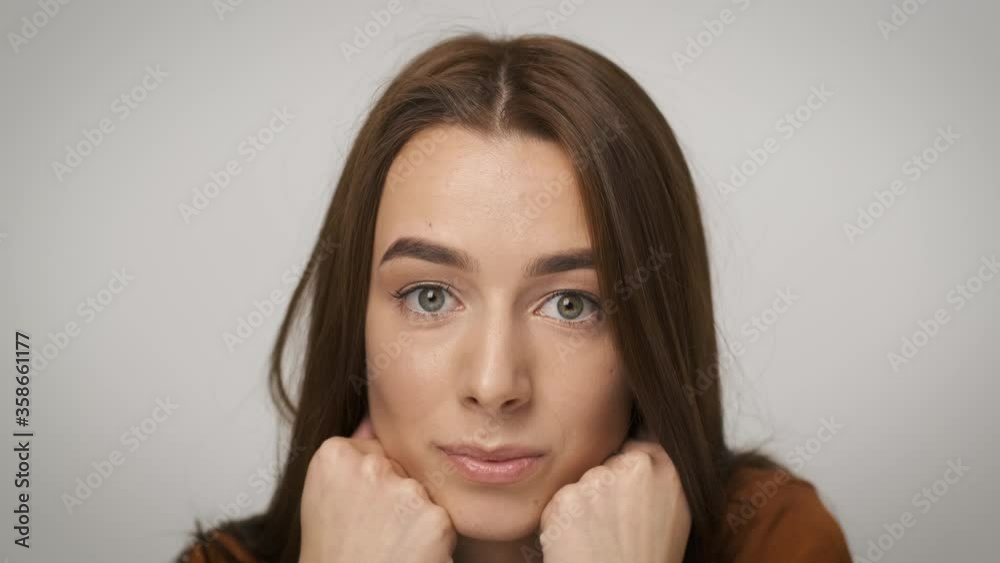 Brunette accountant woman sitting at her desk and smiling sincerely Brunette accountant woman sitting at her desk and smiling sincerely