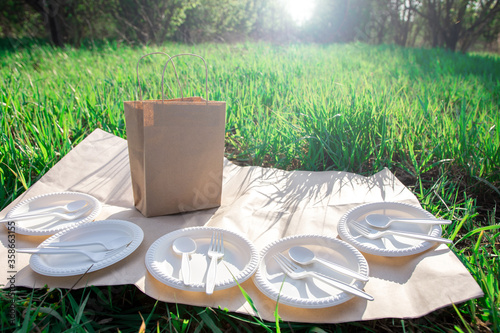 biodegradable corn starch cookware and craft picnic bag. eco friendly. spoons, forks, plates from environmentally friendly materials. modern replacement for plastic.