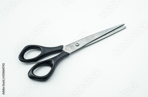 Small hairdressing scissors on white isolate