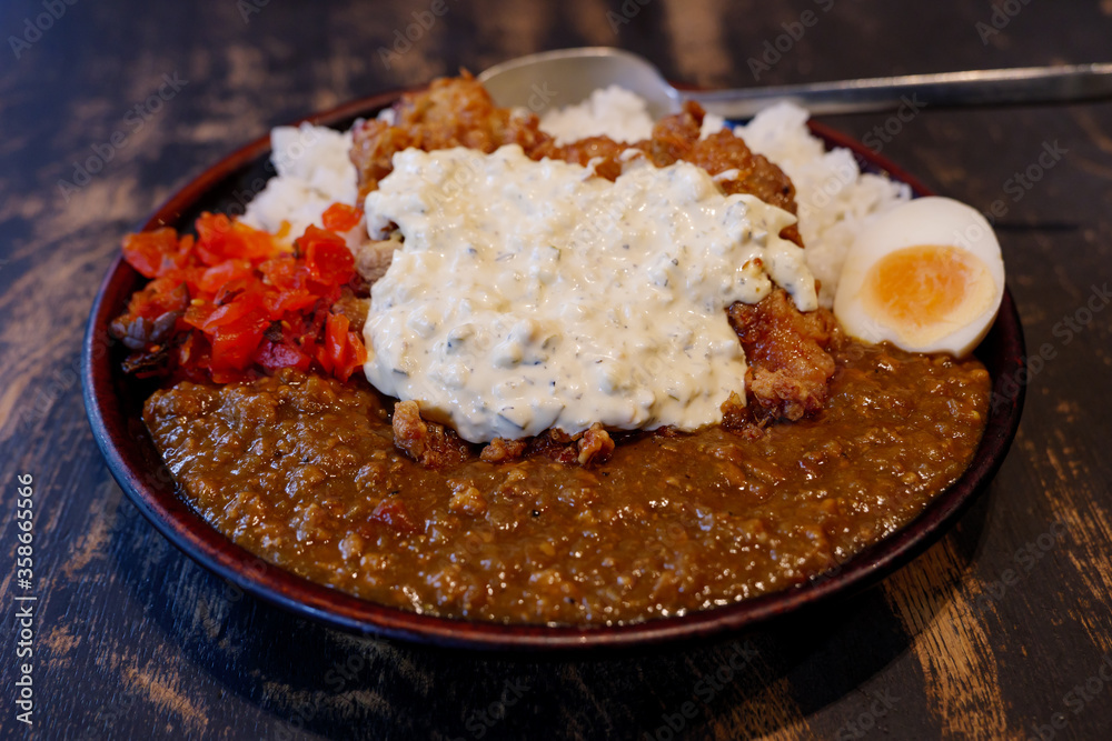 Close up view at Japanese Fried Chicken Nanban style curry with rice, boiled egg and red pickled vegetable. Close up view at Japanese Fried Chicken Nanban style curry with rice, boiled egg and red pickled vegetable.