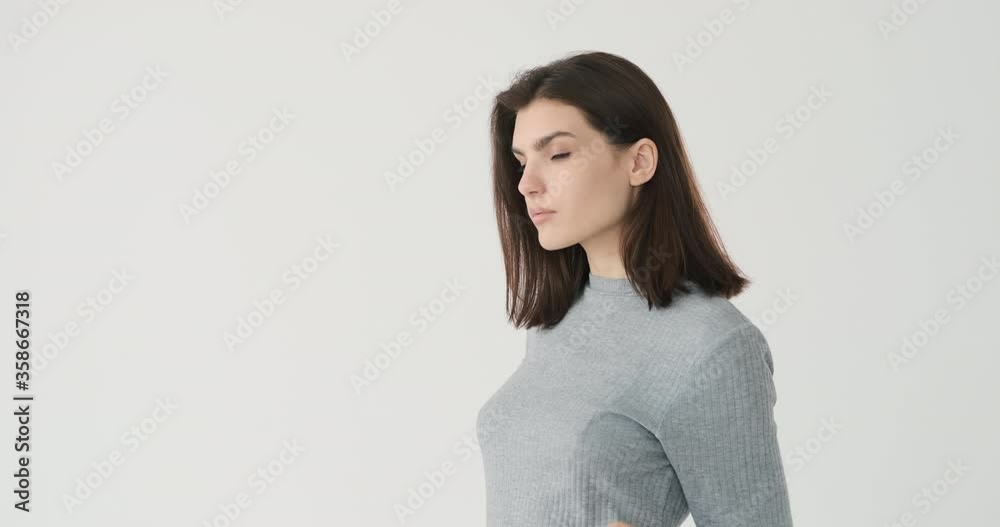 Beautiful woman posing with arms crossed over white background Beautiful woman posing with arms crossed over white background