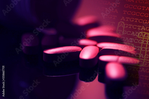 Pills scattered on a glass surface. Dark style.