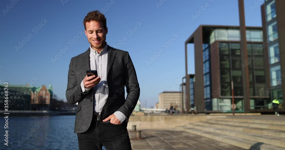 Businessman Using Phone App in Big City Business District Street. SLOW MOTION 59.94 FPS. Businessman Using Phone App in Big City Business District Street. SLOW MOTION 59.94 FPS.