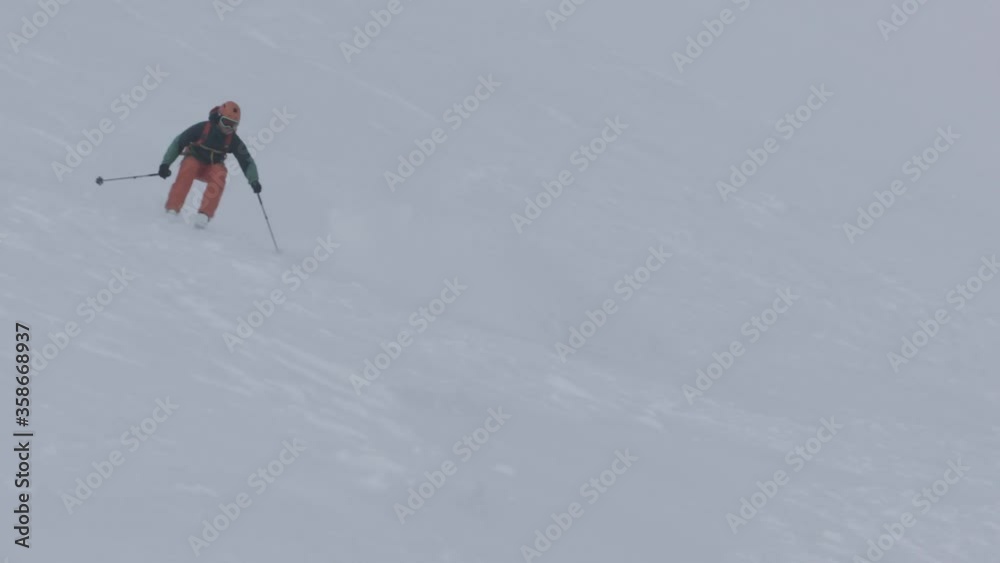 Telephoto tracking shot of Skier carving down steep slope in Scotland. Telephoto tracking shot of Skier carving down steep slope in Scotland.