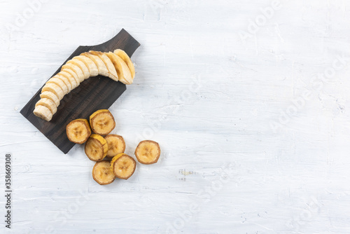 Nanica banana on top of banana leaf on white background. Top View photo