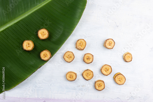 Nanica banana on top of banana leaf on white background. Top View photo