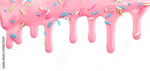 Pink dripping frosting icing with colorful sprinkles isolated on white background