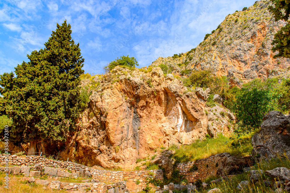 It's Delphi, an archaeological site in Greece, at the Mount Parnassus. Delphi is famous by the oracle at the sanctuary dedicated to Apollo. UNESCO World heritage It's Delphi, an archaeological site in Greece, at the Mount Parnassus. Delphi is famous by the oracle at the sanctuary dedicated to Apollo. UNESCO World heritage
