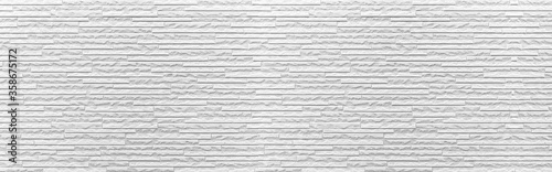 Panorama of white modern stone wall pattern and background seamless