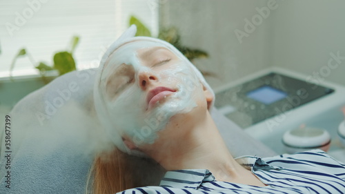 Close-up shot of professional facial skin care treatment with a cosmetic steamer at beauty salon. The Steam cleaning procedure of the face.
