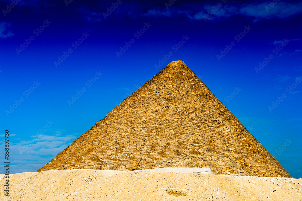 It's Great Pyramid of Giza (Pyramid of Khufu or the Pyramid of Cheops), the oldest and largest of the three pyramids in the Giza Necropolis, the oldest one of the Seven Wonders of the Ancient World