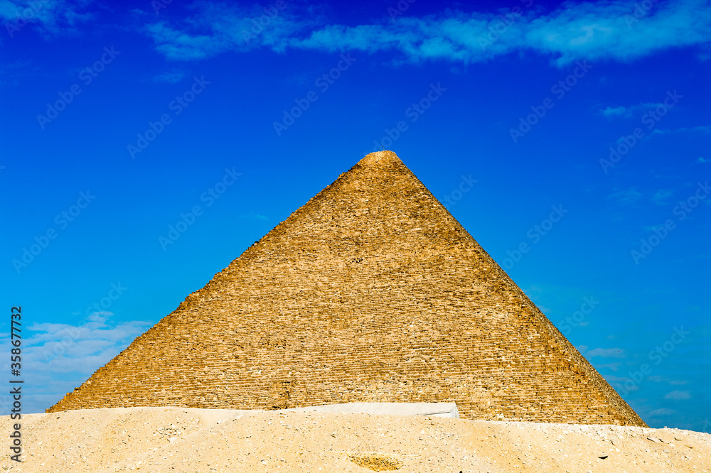 It's Great Pyramid of Giza (Pyramid of Khufu or the Pyramid of Cheops), the oldest and largest of the three pyramids in the Giza Necropolis, the oldest one of the Seven Wonders of the Ancient World
