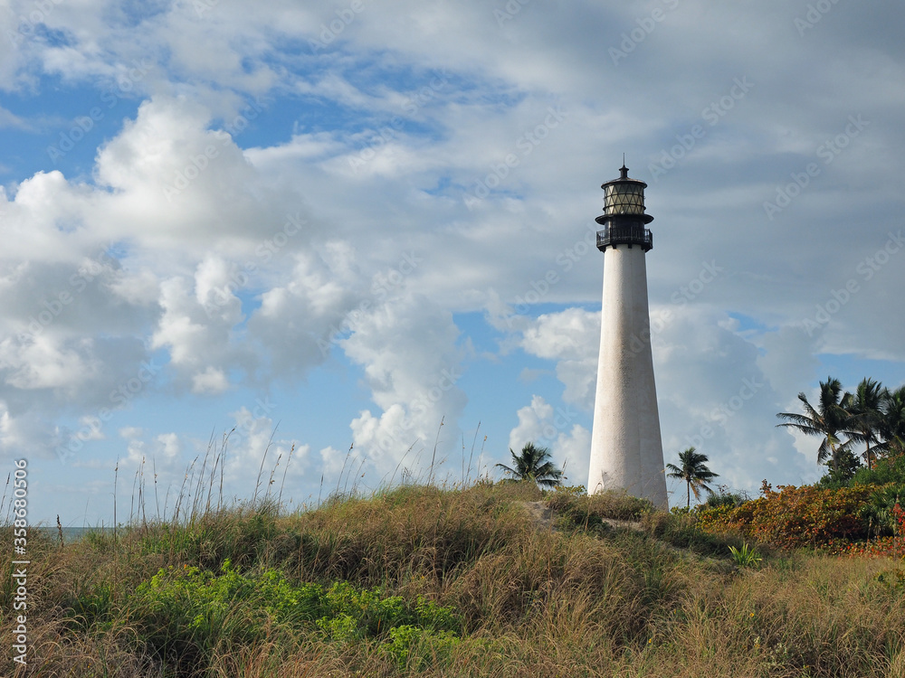 Cape Florida Lighthouse in Bill Baggs Cape Florida State Park on Key Biscayne, Florida on bright cloudy morning.
