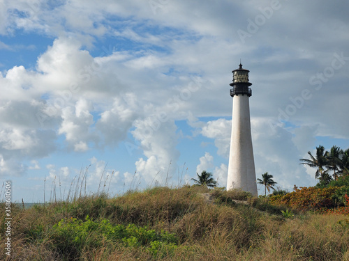 Cape Florida Lighthouse in Bill Baggs Cape Florida State Park on Key Biscayne, Florida on bright cloudy morning.
