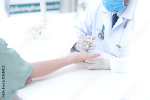 Asian doctors provide vaccines for influenza or influenza shots or needle blood tests. Insulin medication or vaccine Nurse with injection or syringe Hospital office in Asia