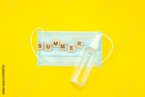 concept of summer 2020 and corona virus inscribed with the words summer on a medical mask, vacation and precautions