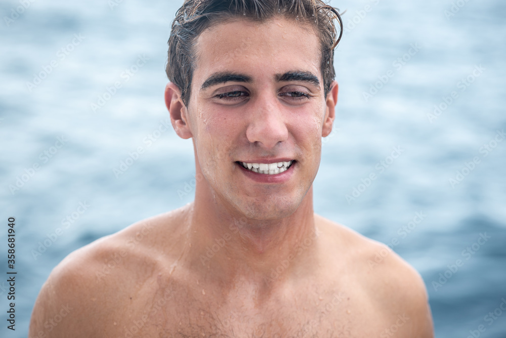 Portrait of young man, surfer with white teeth smile and blue ocean on background. Portrait of young man, surfer with white teeth smile and blue ocean on background.