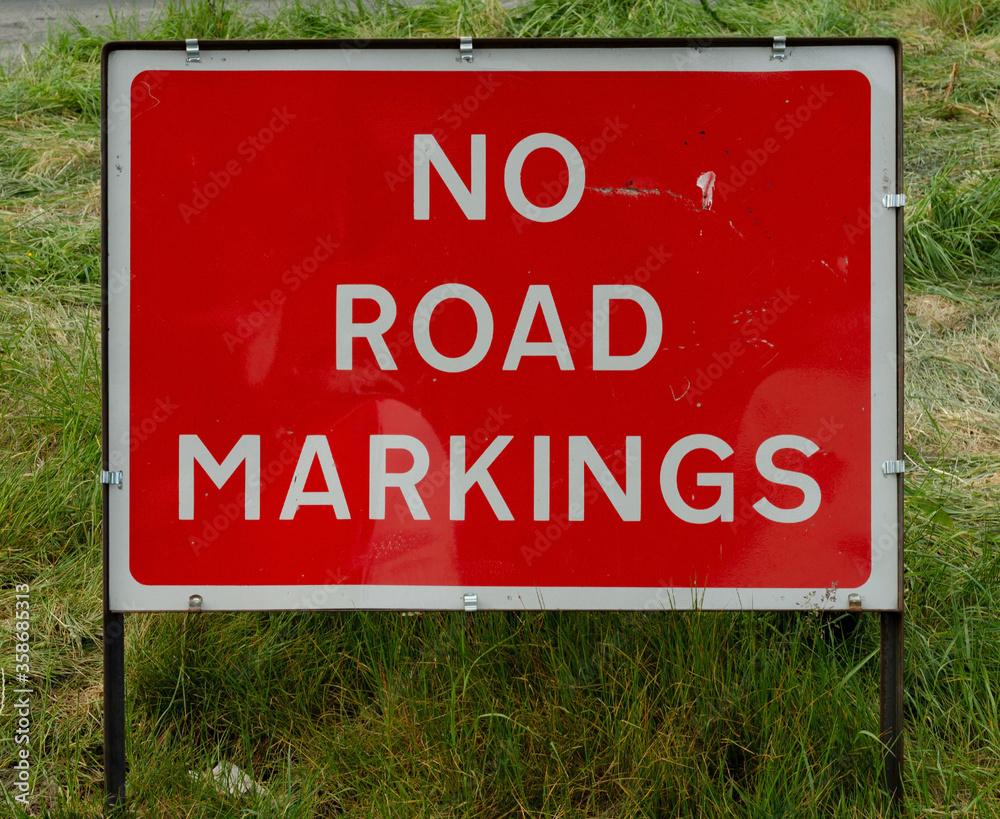 NO ROAD MARKINGS Temporary red road sign or pictogram on a lane in Worcestershire, England, UK NO ROAD MARKINGS Temporary red road sign or pictogram on a lane in Worcestershire, England, UK