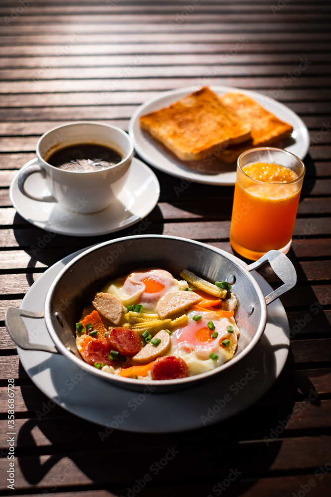 Breakfast or lunch with Fried egg, bread toast, green asparagus, tomatoes and bacon on black plate. Top view. Copy space. Banner. Breakfast or lunch with Fried egg, bread toast, green asparagus, tomatoes and bacon on black plate. Top view. Copy space. Banner.