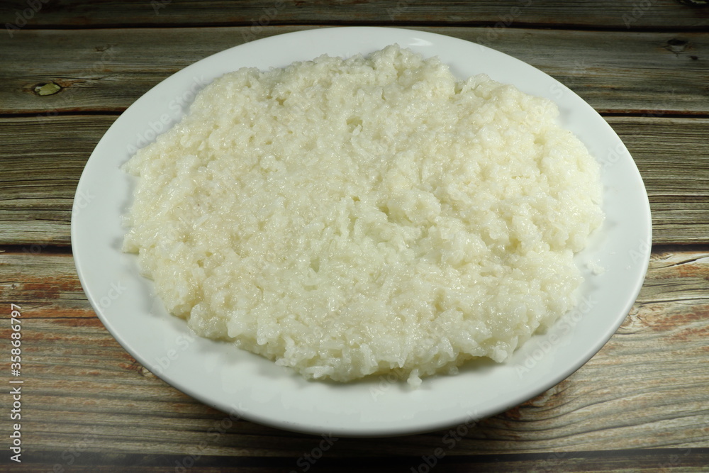 Steamed sticky rice on the white plate. Classic local menu in Thailand street food. Side dish with grilled pork and chicken. Steamed sticky rice on the white plate. Classic local menu in Thailand street food. Side dish with grilled pork and chicken.