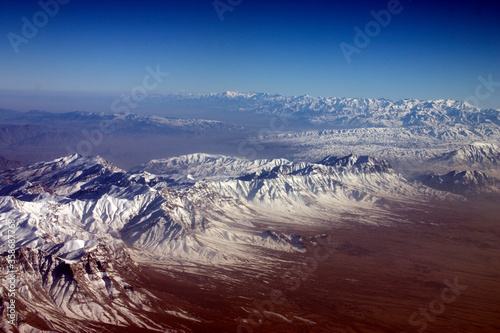 Aerial photograph of the snow covered Hindu Kush mountain range on a cold and crispy winters morning photo