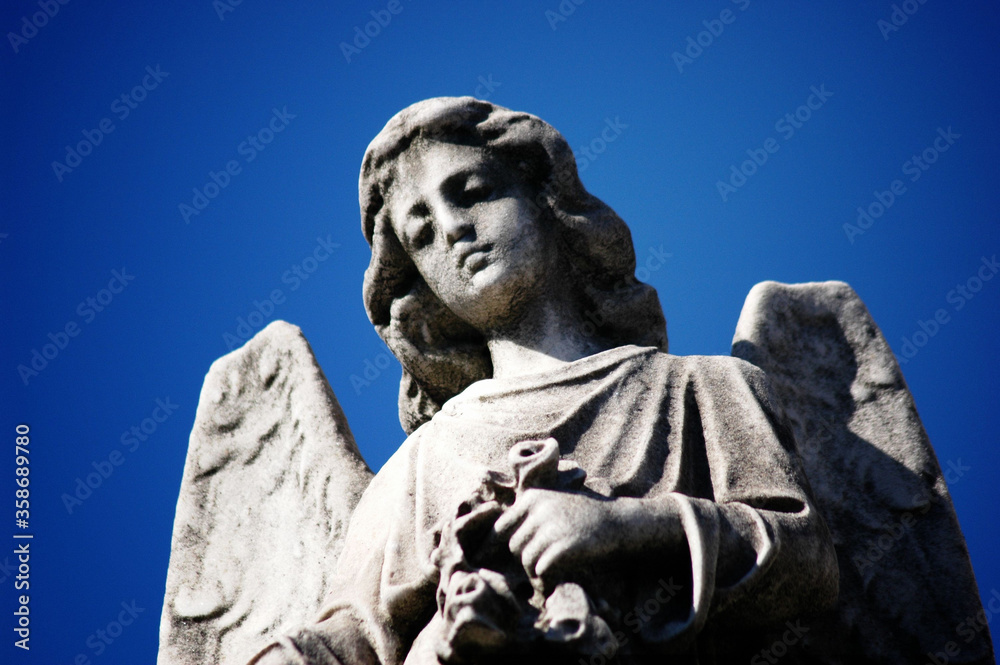 Close View of an Angel Statue Against Blue sky Close View of an Angel Statue Against Blue sky