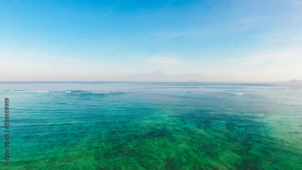 Relaxing seascape with wide horizon of blue sea and clouds on sky