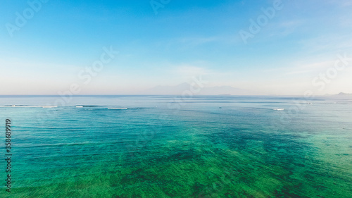 Relaxing seascape with wide horizon of blue sea and clouds on sky