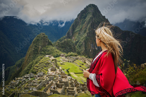 Woman in red dress on vacation in Machu Picchu Cusco Peru
