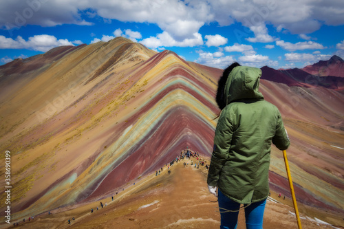 Woman doing trekking in the rainbow mountain in cusco peru