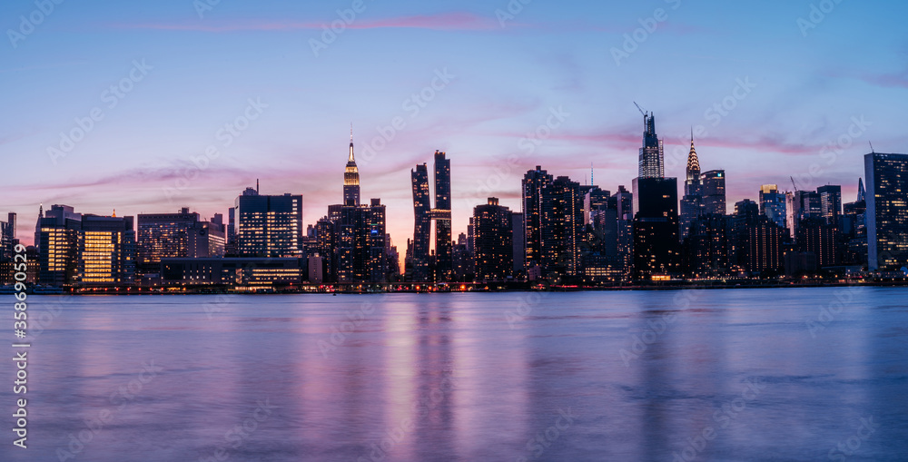 Manhattan Midtown skyline panorama view with Empire State building, Chrysler building, American Copper Buildings, Headquarters of the United Nations. Long Exposure photo