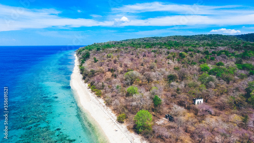 Aerial drone view of an empty white sandy beach in tropical Moyo Island, Sumbawa, Indonesia photo