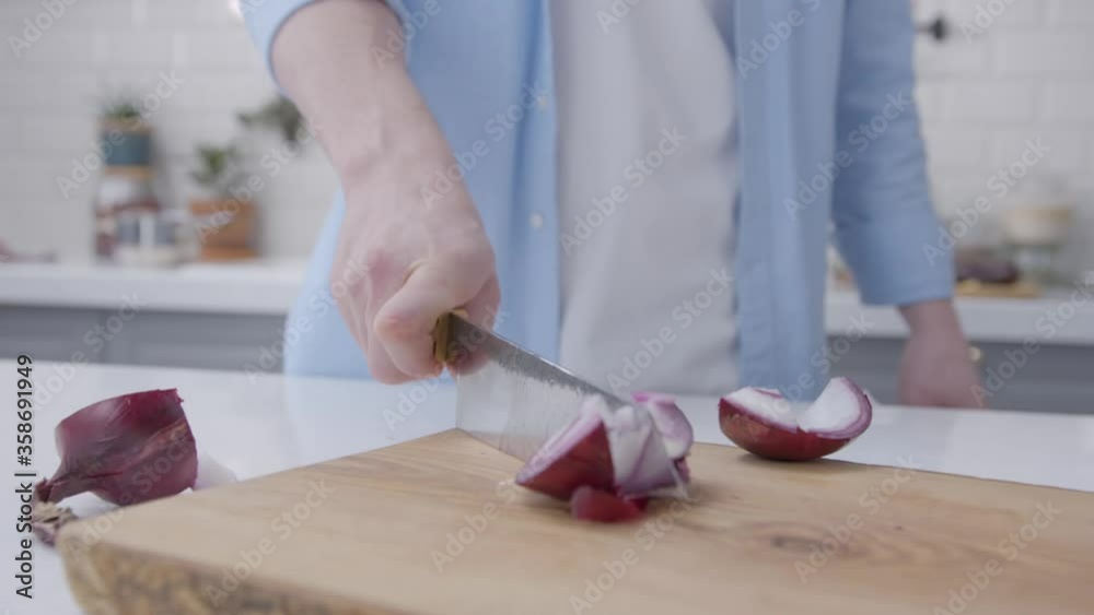 Knife are cutting the red onion. The chef is cutting the onions on a wooden board. Someone's cutting the red onions. Knife are cutting the red onion. The chef is cutting the onions on a wooden board. Someone's cutting the red onions.