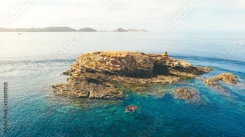 Batu Bolong Island in Komodo National Park, Indonesia. Aerial view of stone island in the midle of sea