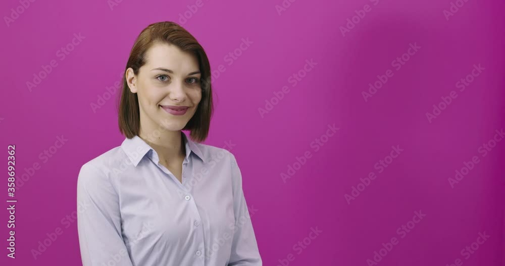 Positive woman smiling over pink backgorund Positive woman smiling over pink backgorund