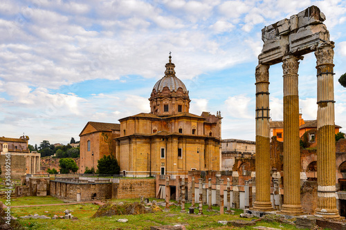 It's Roman Forum in the evening, a rectangular forum surrounded by the ruins of several important ancient government buildings at the center of the city of Rome.