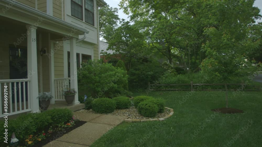 Front yard of house in the suburbs on a summer evening. Front yard of house in the suburbs on a summer evening.