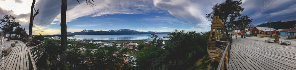 Super wide panorama of Puerto Williams waterfront promenade, the sea and nature in a beautiful day, Chilean Patagonia