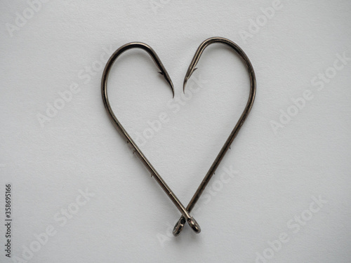 Two big fishing hooks in the shape of hearts photo