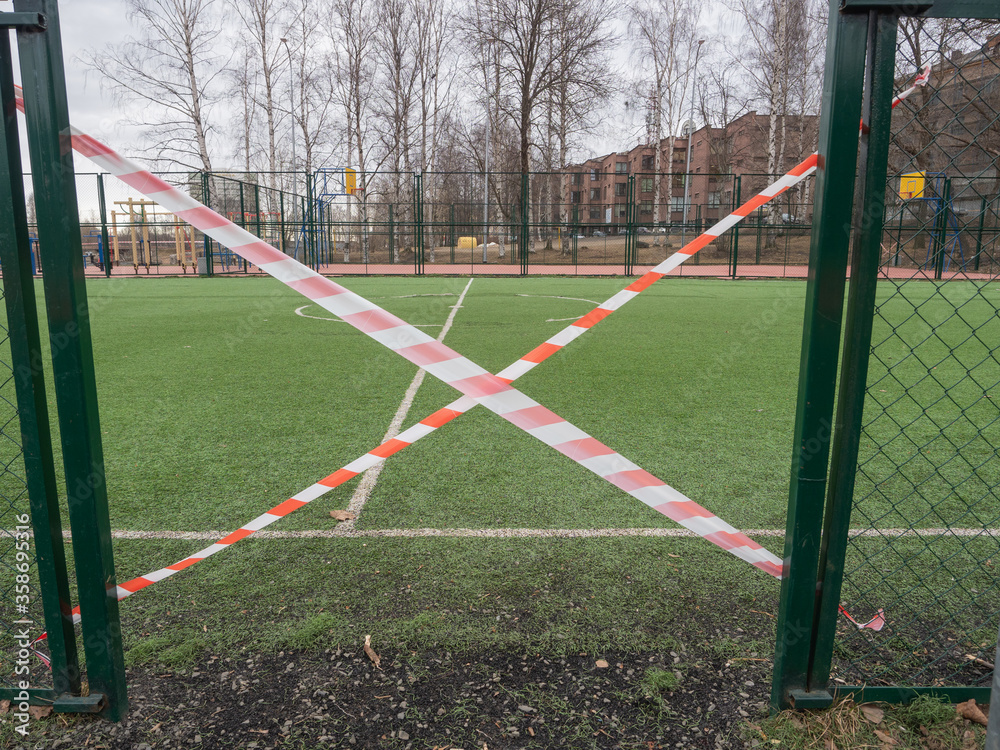 Football field in Petrozavodsk (northwest of Russia) fenced with tape during quarantine for coronavirus infection COVID-19