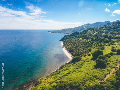 Aerial view of hill and sea. Beautiful landscape of Lombok Island, Indonesia. Nipah Hill in North Lombok with coconut trees