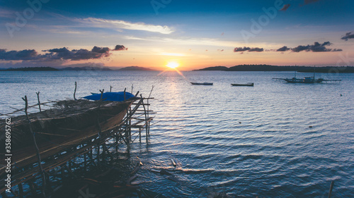 A traditional half fisherman boat made with great sunset landscape in Sumbawa, Indonesia