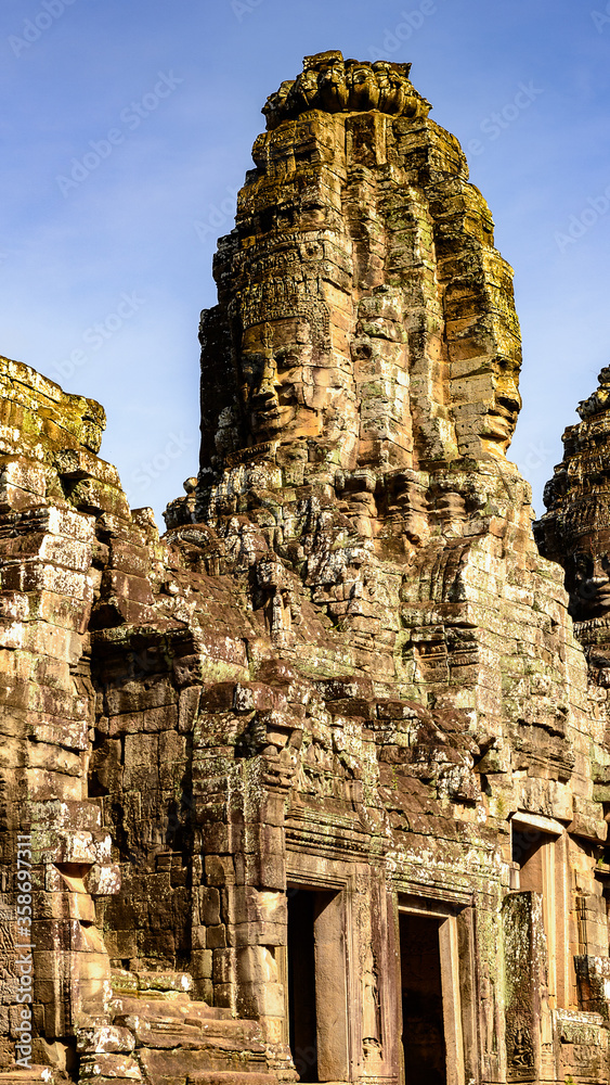 It's Bayon, Khmer temple at Angkor in Cambodia. Official state temple of the Mahayana Buddhist King Jayavarman VII