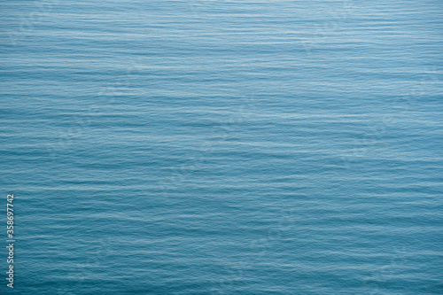 Blue sea water surface with waves, top view