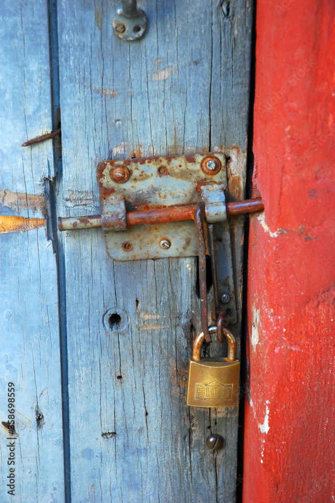 Wooden door with bolt and padlock Wooden door with bolt and padlock
