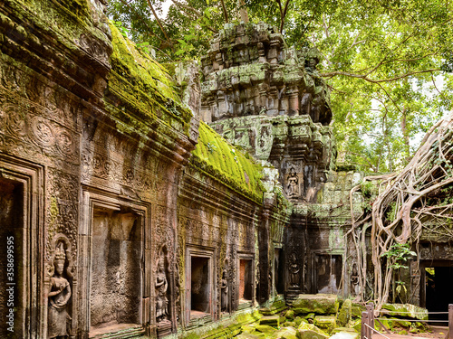 It's Tree roots over the Ta Prohm (Rajavihara), a temple at Angkor, Province, Cambodia. It was founded by the Khmer King Jayavarman VII as a Mahayana Buddhist monastery and university. photo
