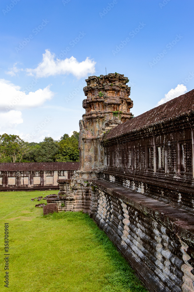 It's Wall of the Angkor Wat (Temple City), a Buddhist temple complex in Cambodia and the largest religious monument in the world. View from the garden