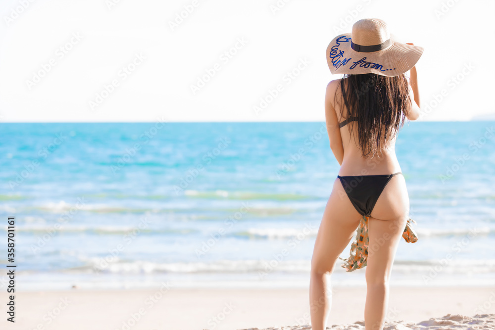 Young women wearing bikini on tropical beach Young women wearing bikini on tropical beach
