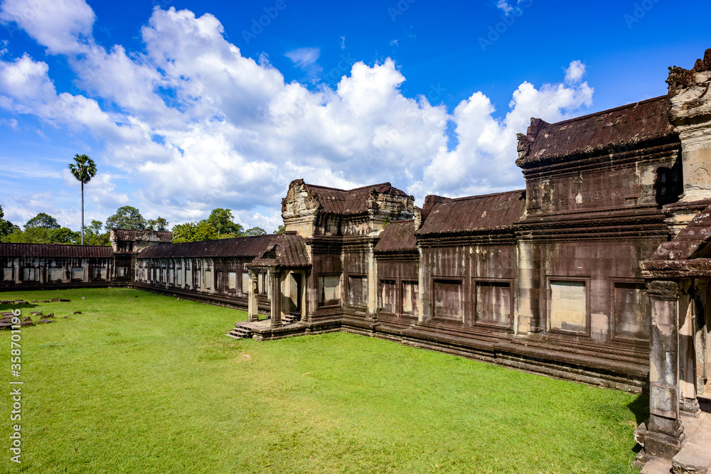 It's Wall of the Angkor Wat (Temple City), a Buddhist temple complex in Cambodia and the largest religious monument in the world. View from the garden